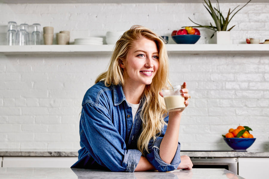 Woman enjoying a glass of the creamiest organic non dairy almond milk.